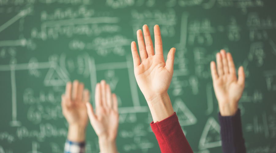 Photo of hands being raised in a class