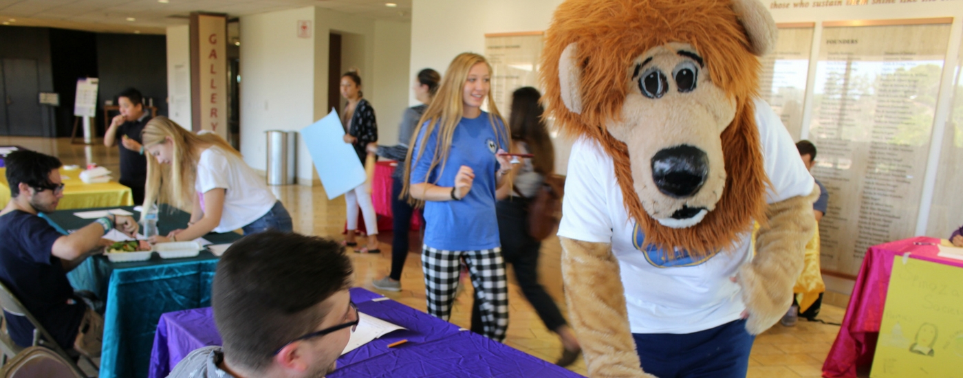 Photograph of mascot, Zion the lion with students