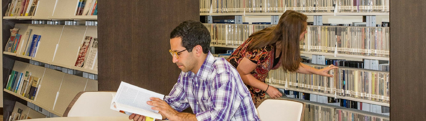 Photograph of two students in the library