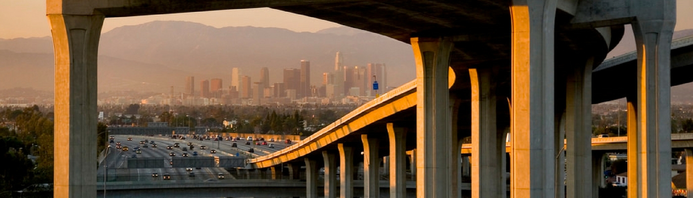 Image of Los Angeles Downtown skyscape in distance over freeway