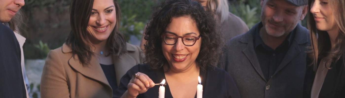 Photograph of women lighting shabbat candles