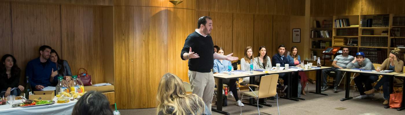 Photograph of classroom with instructor speaking to students