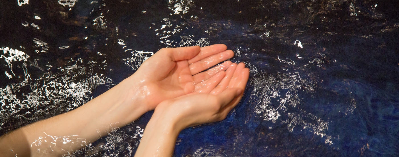 Photograph of Hands in the Mikveh Waters