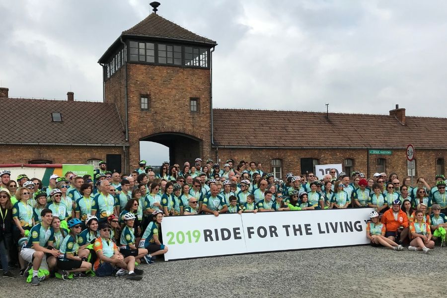 Photograph of cyclists in front of concentration camp for Ride for the Living