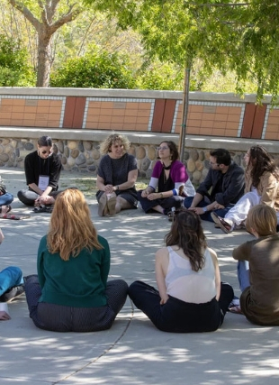 Photo of people sitting ins a circle at the artist retreat