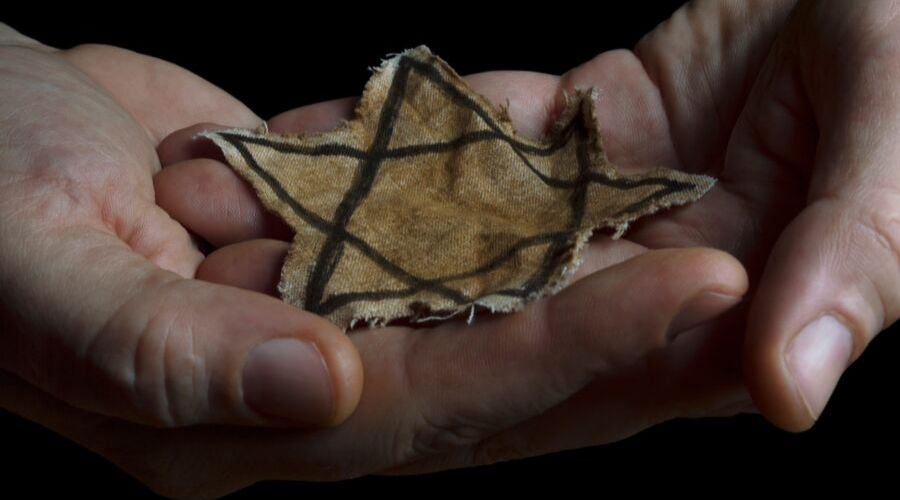 Photo of Hands holding Holocaust Jewish Star