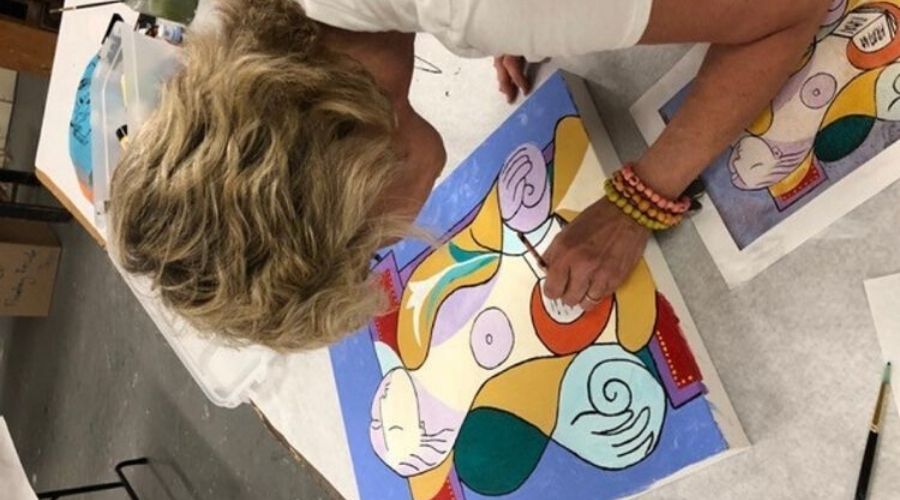 woman painting at a table