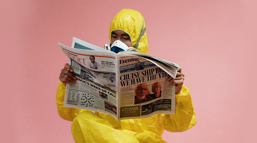 Photo of Man in Yellow Suit reading Paper