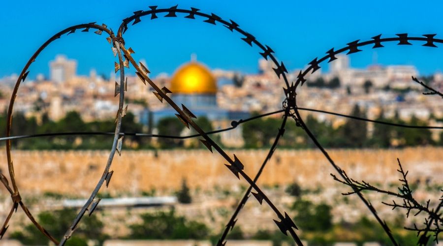 barbed wire with Jerusalem in the background