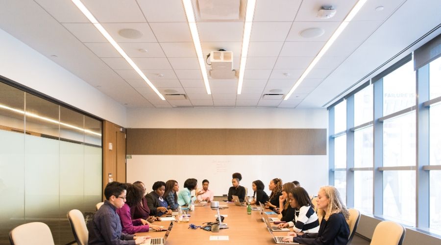 people sitting around a table in a board room