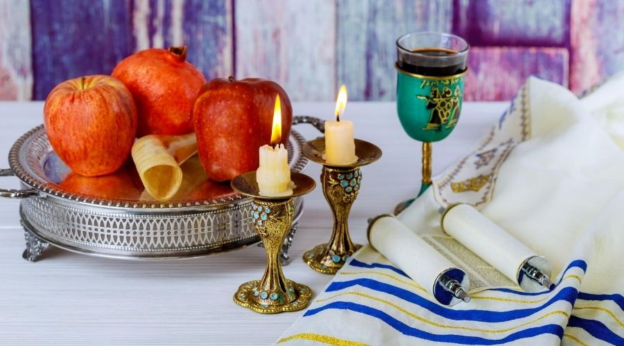 table with apples, honey, and candles for new year