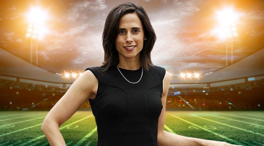 Heather Brooks Karatz standing in front of a football stadium