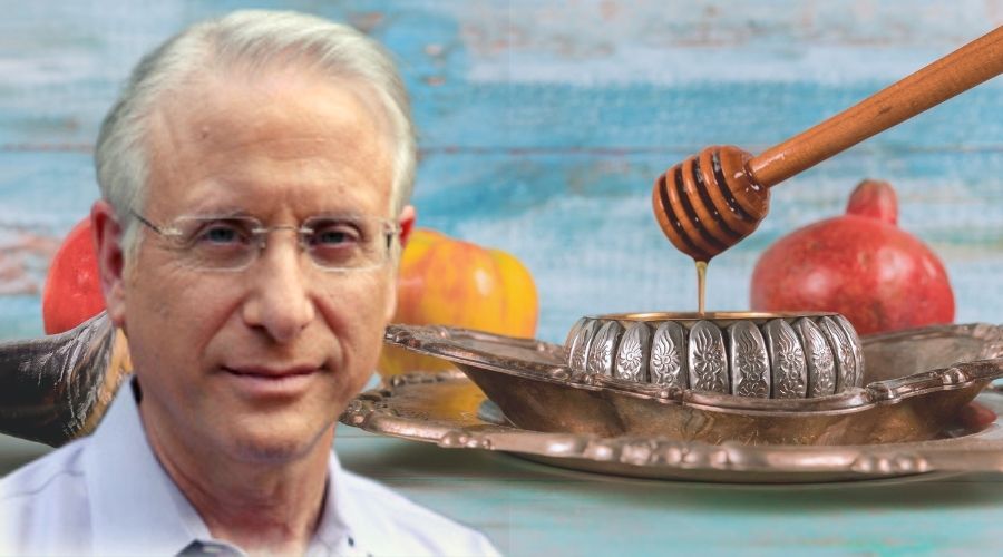 Michael Andron in front of a shofar and apples and honey