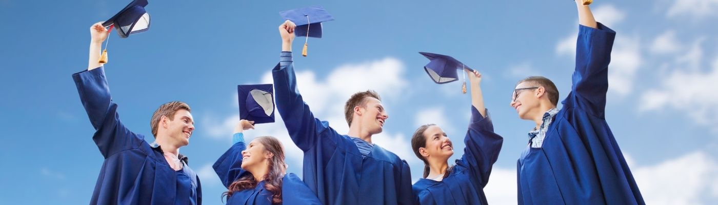 Photo of graduates with caps in hand