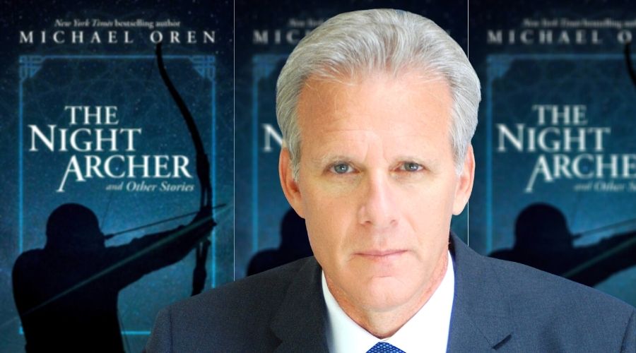 Michael Oren in front of his book cover