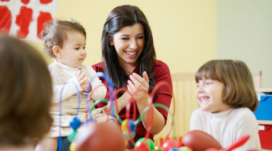 Photo of ECE teacher and students in a classroom 