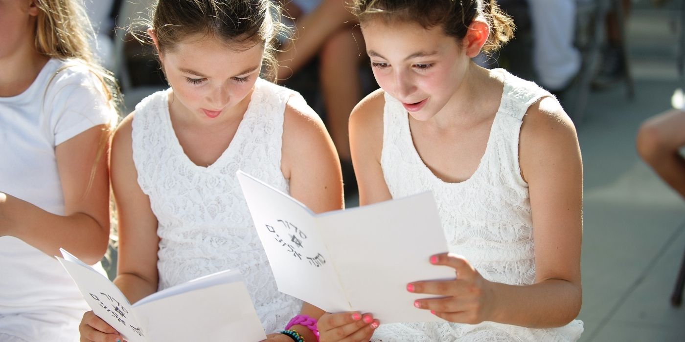 two young girls reading