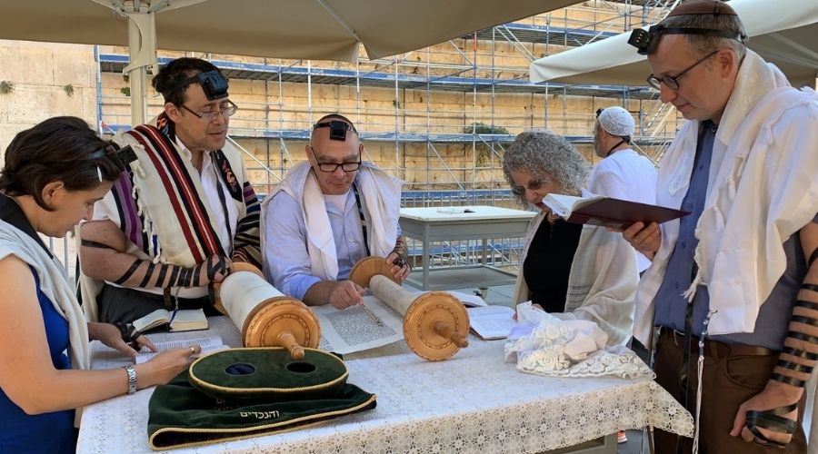 Rabbi Artison and other rabbis surround a Torah at the Kotel