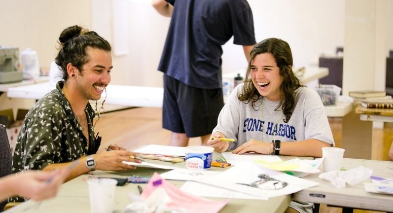 Photo of man and woman doing arts and craft and smilling
