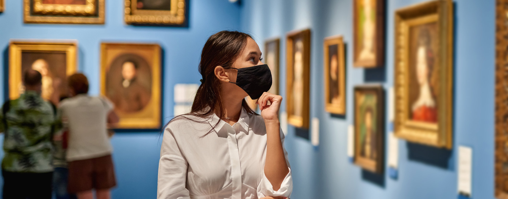 Masked Woman Looking at Painting
