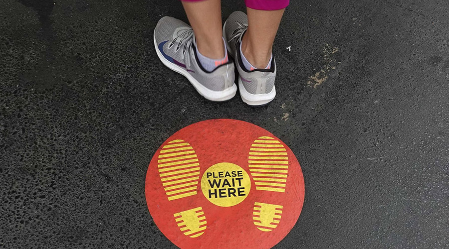 photo of feet and sign on sidewalk