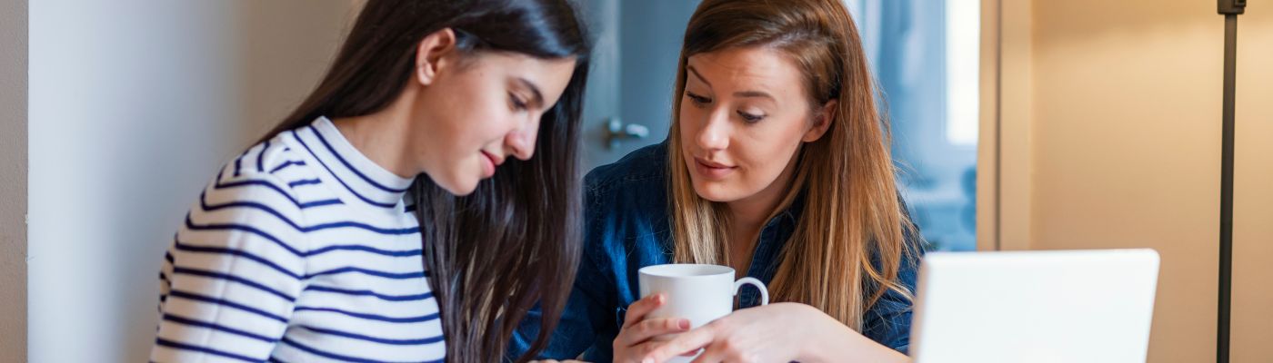 Photo of parent and teen at computer