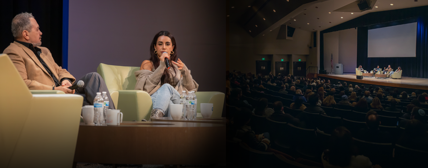 Interview on stage in auditorium with audience watching