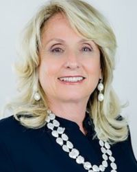 Headshot of Fern Topas Salka with white necklace