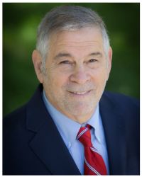 Headshot of Michael Berenbaum in red tie