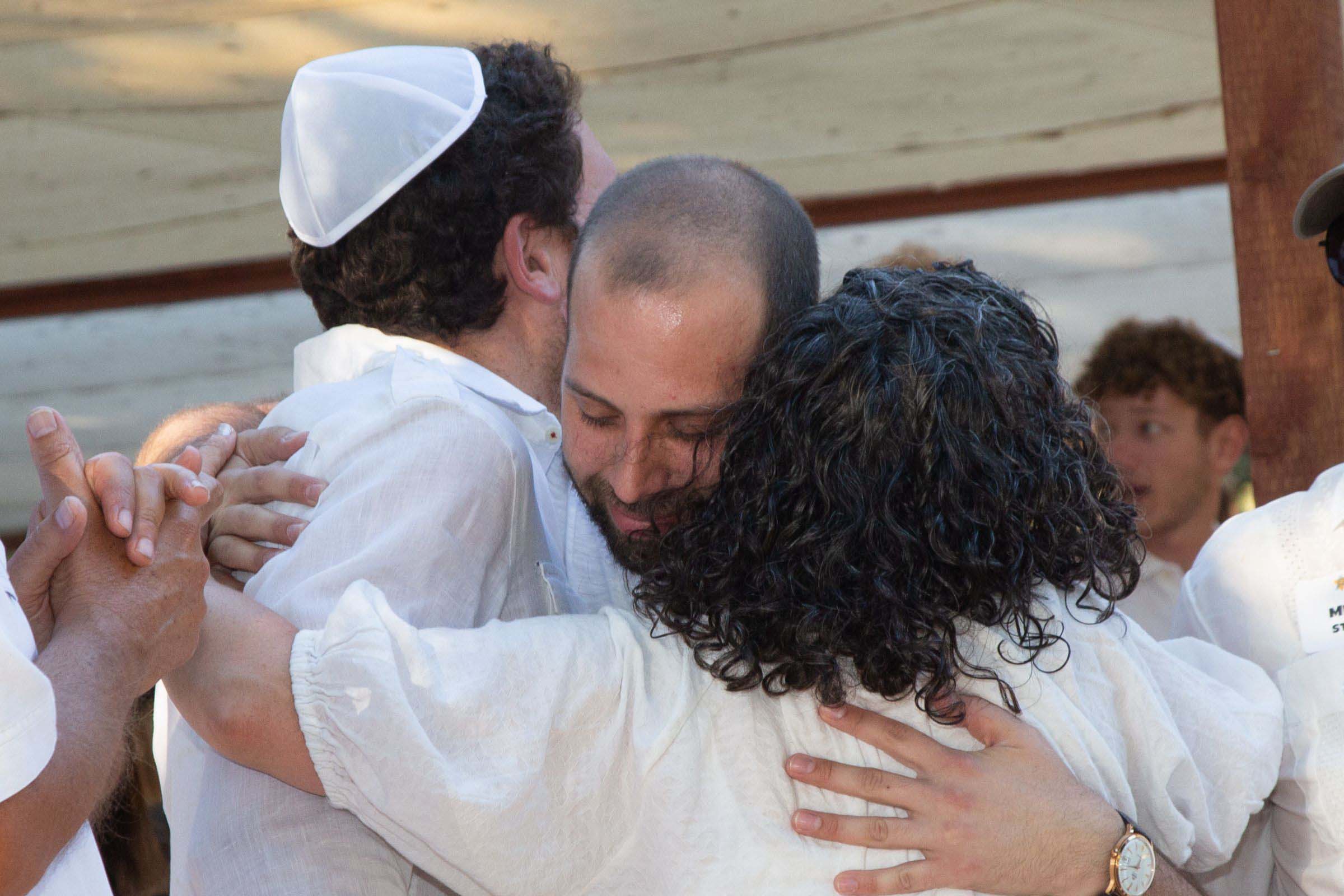 Three people hugging