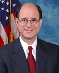 Headshot of congressman Brad Sherman with red tie and black blazer