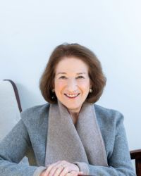 Headshot of Deborah Dwork with gray scarf and light blue jacket