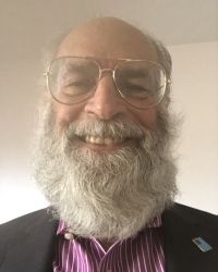 David Meir-Levi headshot in purple shirt with black jacket