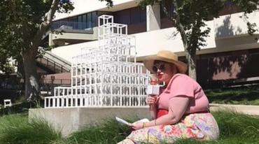 Woman sitting on grass in the sculpture garden