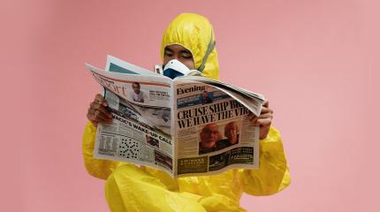 Photo of Man in Yellow Suit reading Paper
