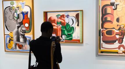 person standing in front of a painting in a gallery