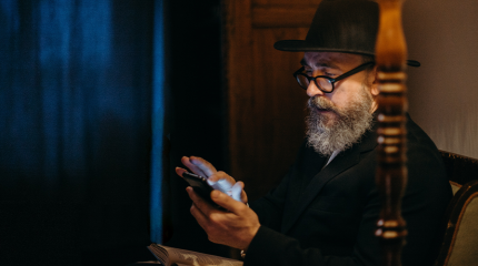 rabbi texting on a cell phone