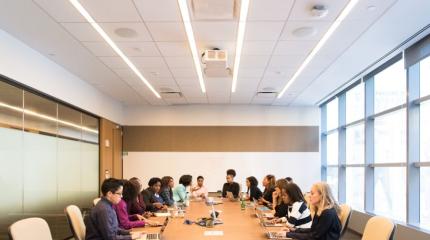 people sitting around a table in a board room