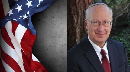 bruce powell standing in front of the american flag