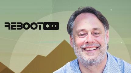 presenter next to his company's logo