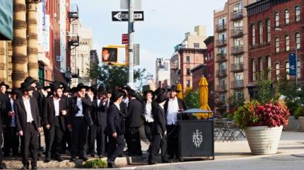 Orthodox Jews standing on a street corner in Brooklyn