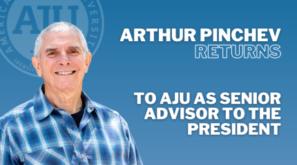 Arthur Pinchev headshot blue checkered shirt blue background