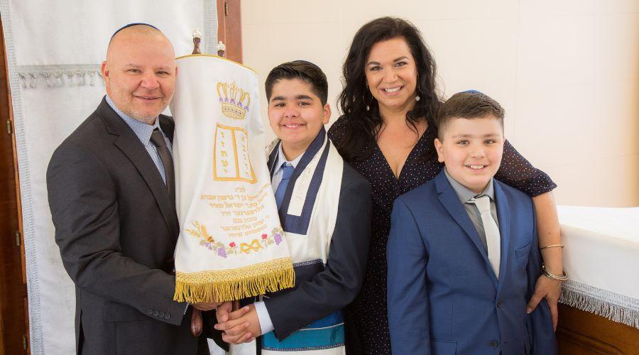 Photo of Mendoza Family, Mario, Sharon, Noah and Joshua, at Noah's Bar Mitzvah Holding the Torah