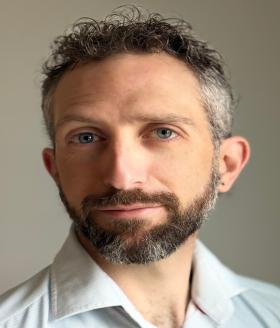 Headshot of Rafa Kern in collared shirt